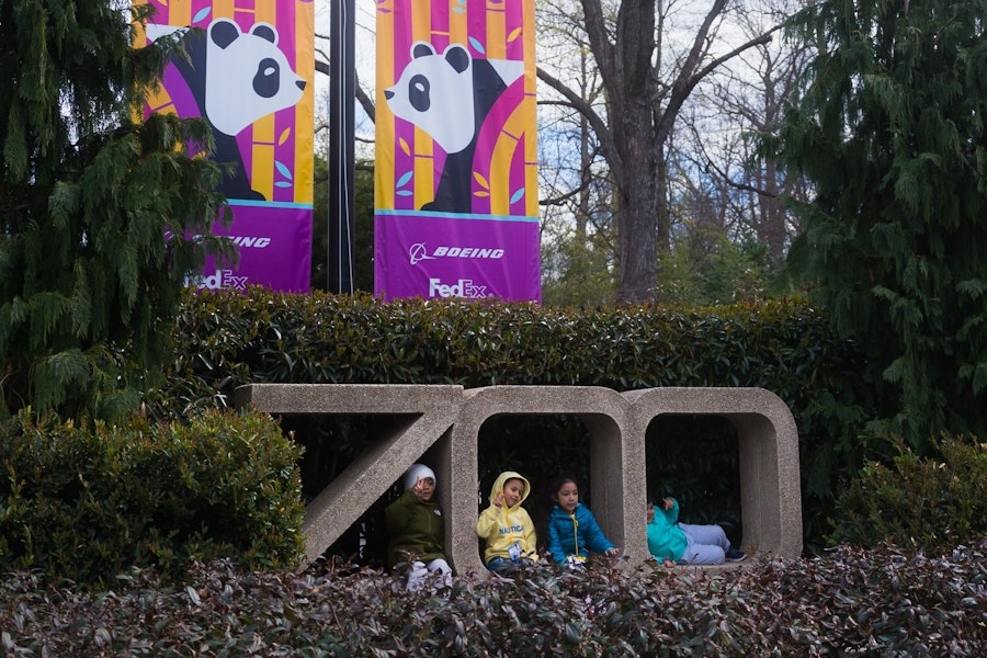 Kids pose for a photo out front of the National Zoo. 