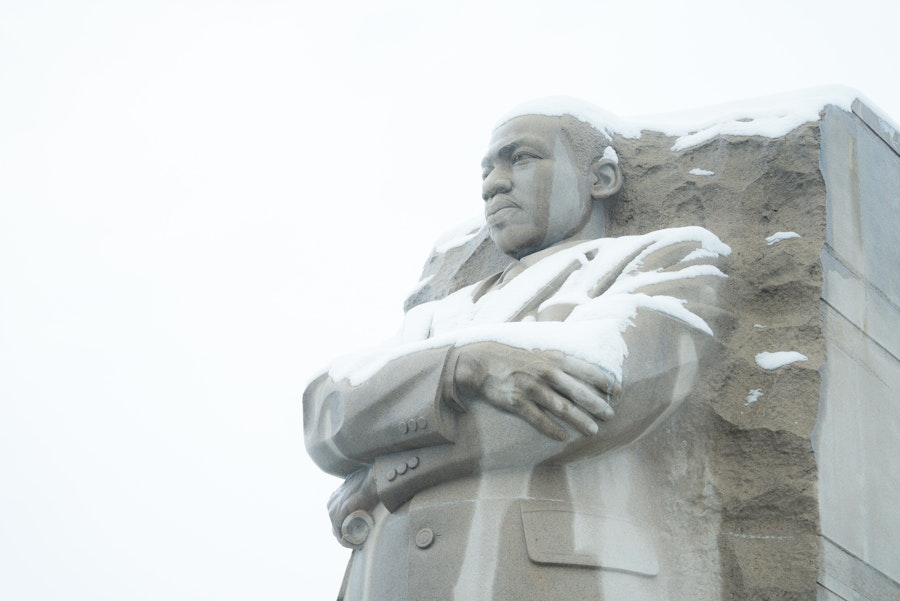 Snow rests on the stone figure of Martin Luther King Jr. at his Washington, DC Memorial.