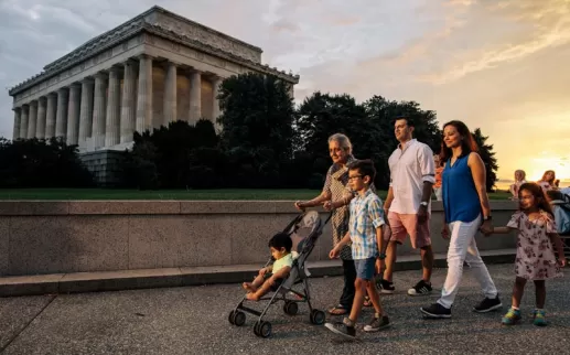 Family walking on the National Mall in front of the Lincoln Memorial during a summer evening in Washington, DC