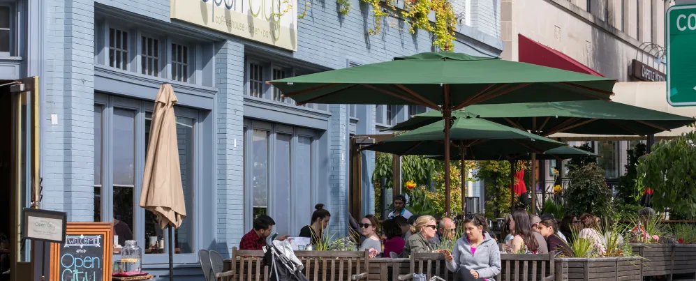 People enjoy outdoor seating at Open City in Washington, DC on a sunny day.
