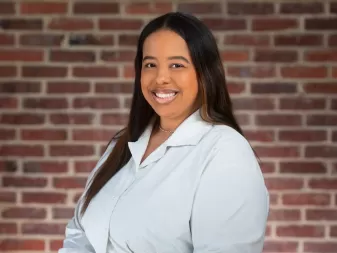 A woman smiles for a professional headshot. 